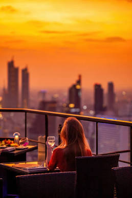 Rooftop bar at sunset over the Bangkok skyline